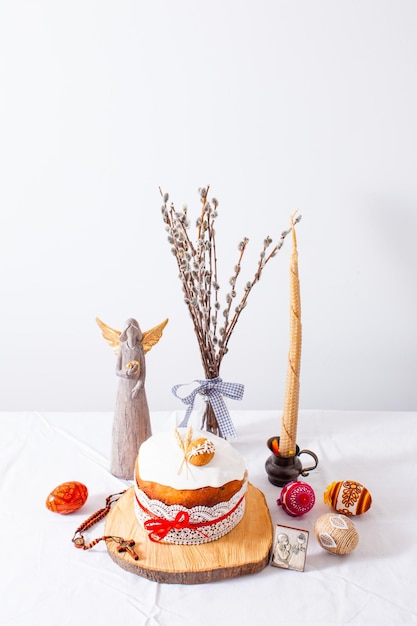 Easter cake and colored eggs on white background