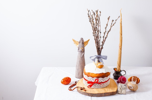 Easter cake and colored eggs on white background