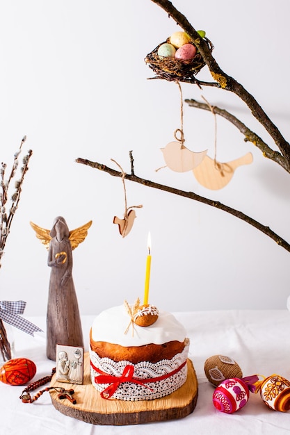 Easter cake and colored eggs on white background