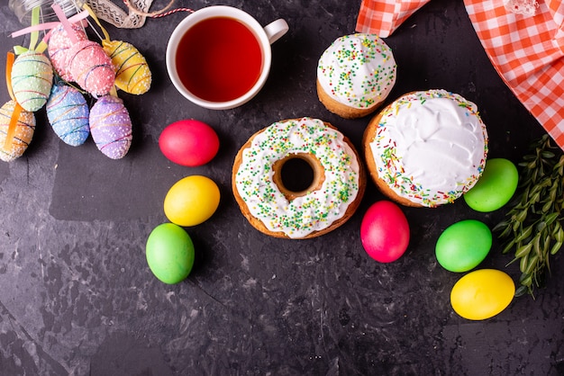 Easter cake and colorful eggs on a dark background 