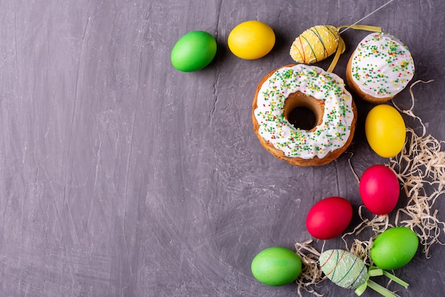 Easter cake and colorful eggs on a dark background 