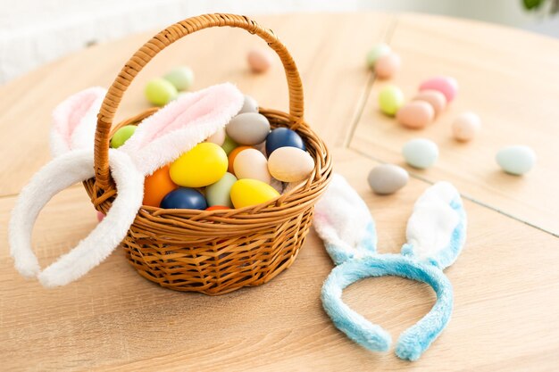 Easter cake and colorful eggs and flowers on the foreground.