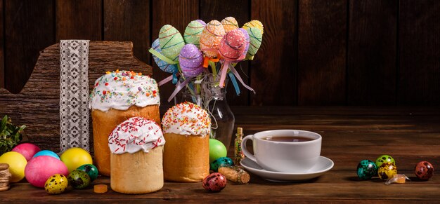 Easter cake and colorful eggs with tea cup