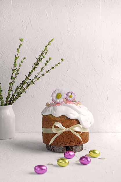 Easter Cake decorated with meringue and flowers on white background and white table with copy space Light EasterOrthodox holiday background copy space