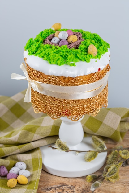 easter cake made from yeast dough, decorated with edible moss with a nest and chocolate eggs. 