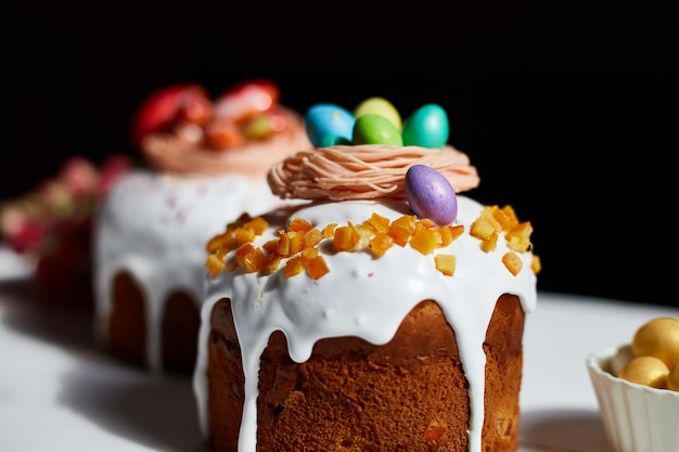 Easter cake with chocolate eggs decoration on white wooden table