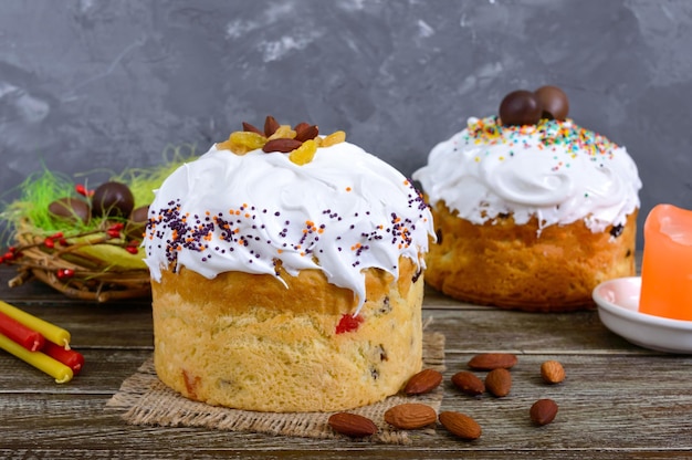 Easter cakes, painted eggs, chocolate sweets, and other attributes of Easter. Sweet festive bread with meringue cream.