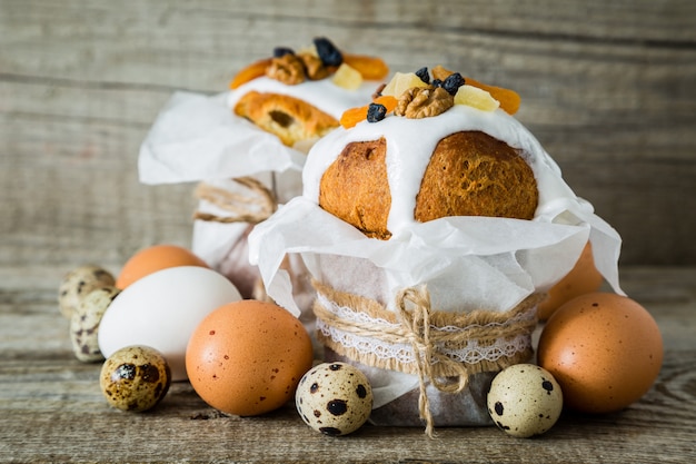 Easter cakes with eggs, rustic wood background