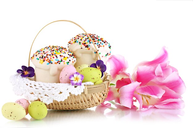 Easter cakes with eggs in wicker basket isolated on white