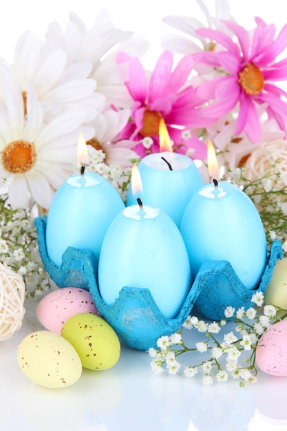 Easter candles with flowers close up