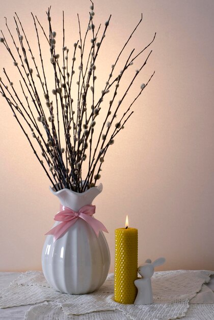 Easter card Willow branches a yellow wax candle Banner Minimal concept Copy space for text