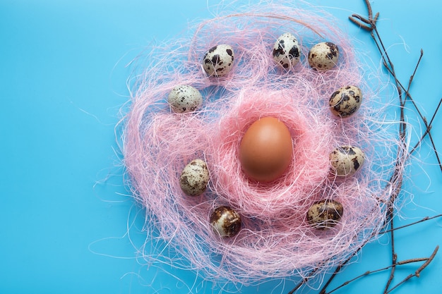 Easter card with eggs in nest over wood. Top view