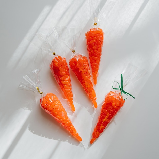 Sacchetti di ossequio della carota di pasqua con l'idea del fagiolo di gelatina per i bambini dolci pasquali buon concetto di vacanza di pasqua