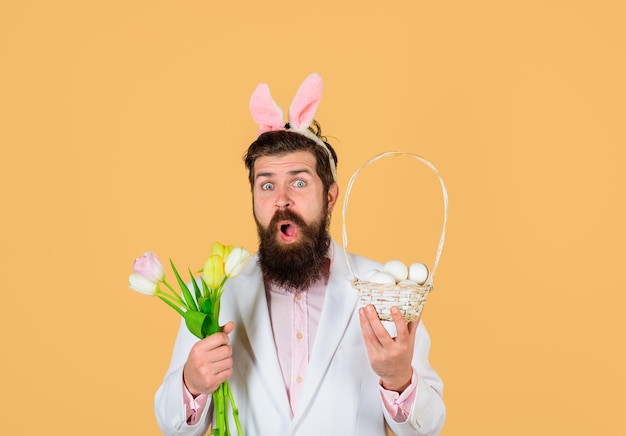 Easter celebration happy easter surprised bearded man in suit hold basket of egg spring flowers