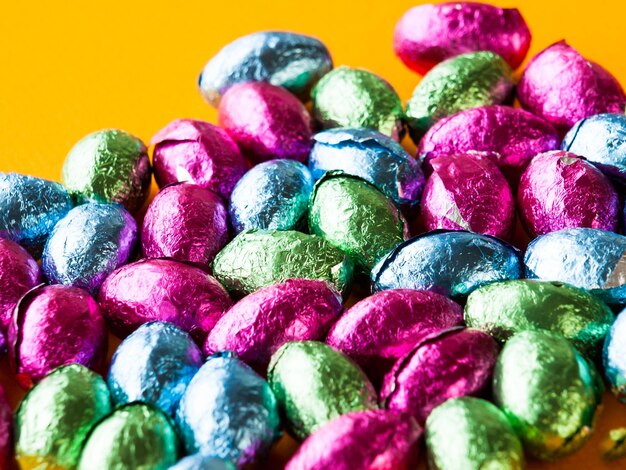 Photo easter chocolate candies on color background.