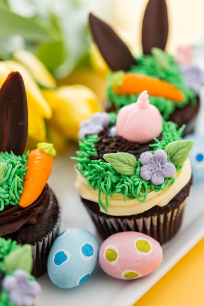 Easter chocolate cupcakes decorated with piggy and bunny ears.