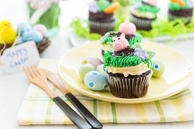 Easter chocolate cupcakes decorated with piggy and bunny ears.