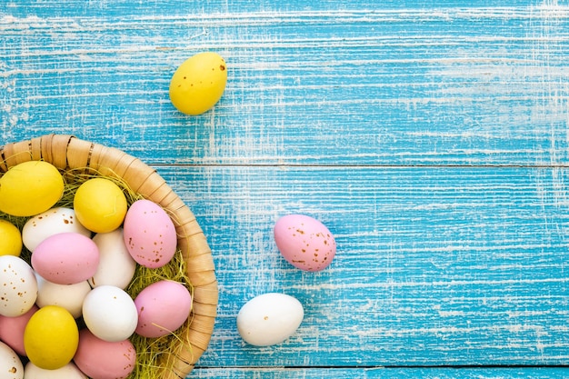 Easter chocolate eggs on a blue wooden background flat lay copy space