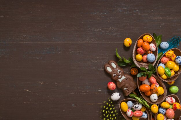 Easter chocolate eggs and bunny on wooden table