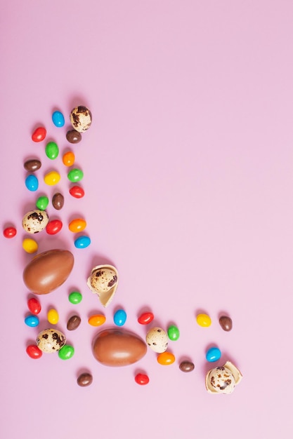 Easter chocolate eggs on pink paper background