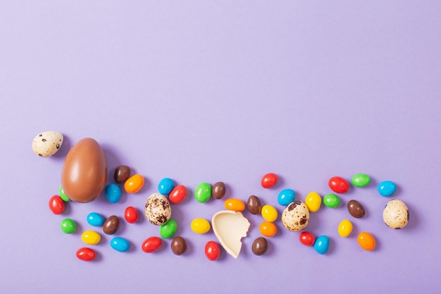 Easter chocolate eggs on purple paper background