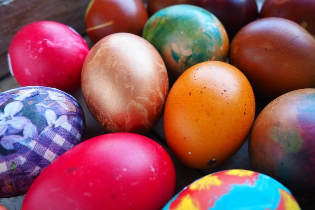 Easter colorful eggs close up Many colorful holiday eggs are stacked close to each other Boiled chicken eggs with floral and fantasy pattern Bright Easter background