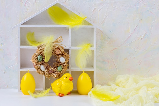 Easter composition: chicken, eggs, feathers and decor