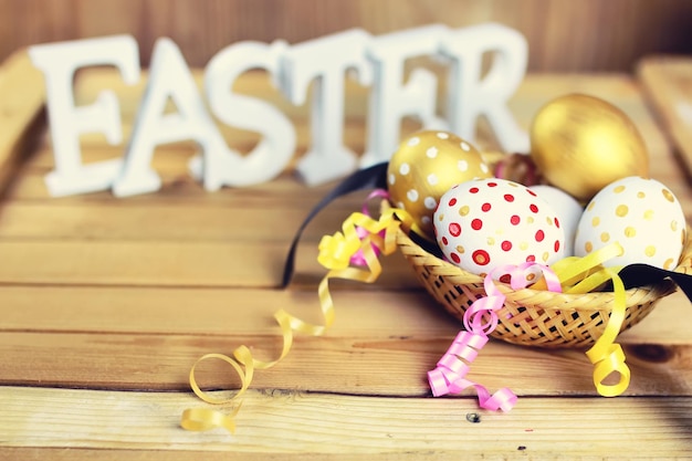 Easter composition flower and eggs on wooden background