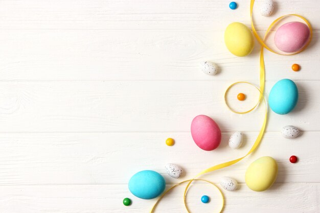 Easter composition of painted eggs and feathers on a colored background. Easter background. High quality photo