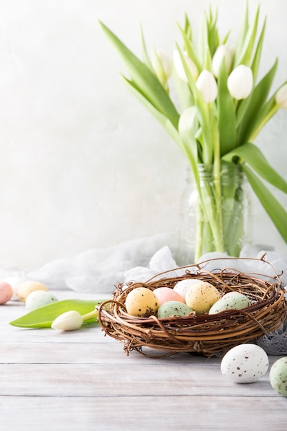 Easter composition of quail eggs in the nest