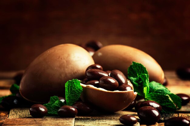 Easter composition with chocolate eggs vintage wooden background rustic style selective focus