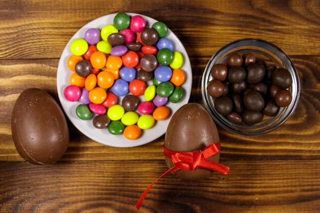 Easter composition with chocolate eggs on wooden background Top view