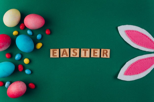 Photo easter composition with colored eggs and rabbit ears