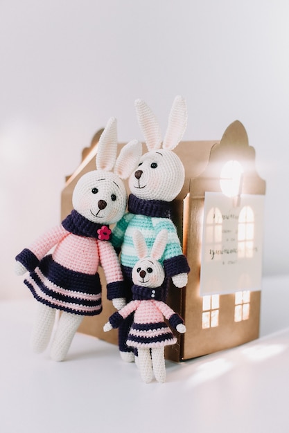 Easter composition with a cute family of handmade knitted bunny rabbits