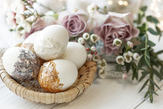 Easter composition with decorative eggs and flowers closeup