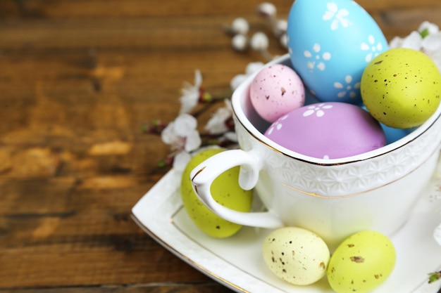 Easter composition with flowering branches on wooden table closeup