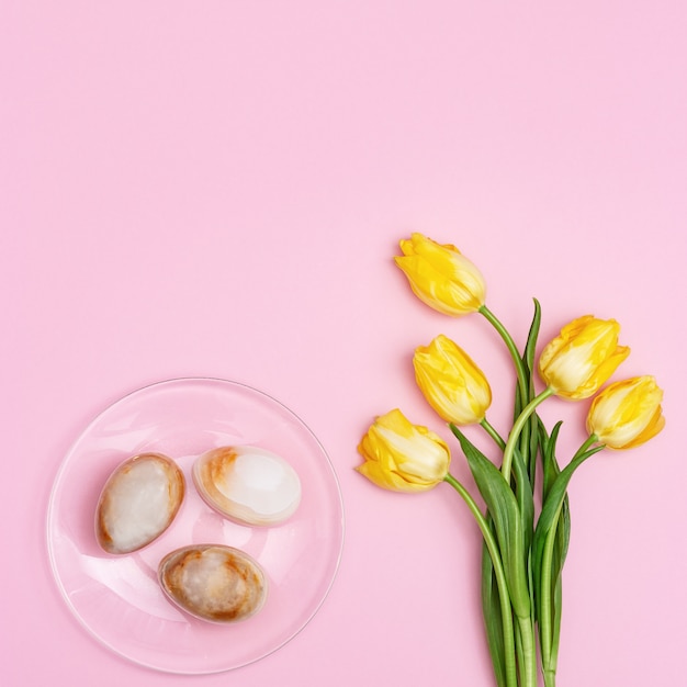 Easter composition with natural flower of tulips and decorative eggs from gemstone onyx. Spring Easter holiday