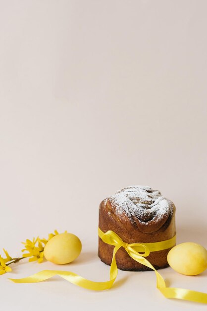 Easter composition with orthodox sweet bread kulich and eggs on beige background Easter holidays