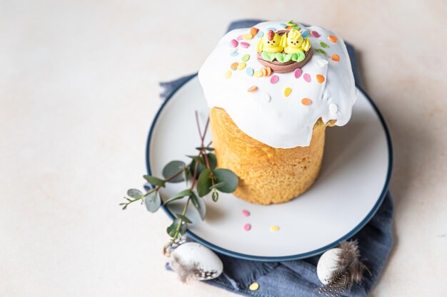 Easter composition with Orthodox sweet bread Kulich with meringue icing sprinkles and eucalyptus