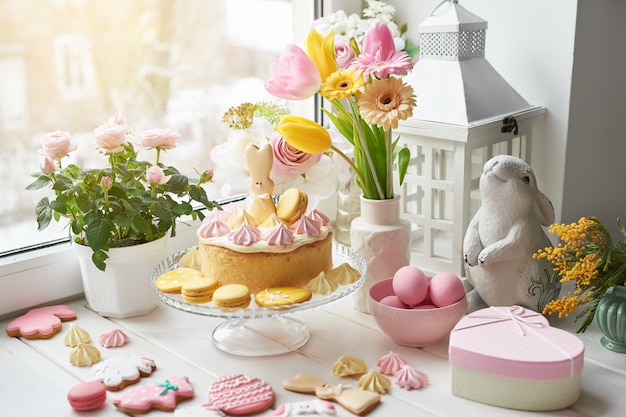 Easter composition with pink eggs, ceramic bunny and flowers in a vase