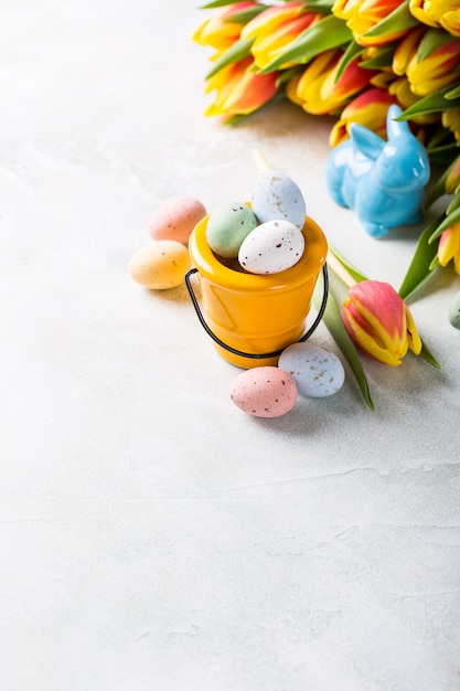 Easter composition with quail eggs and tulips