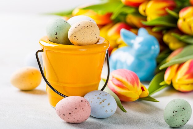 Easter composition with quail eggs and tulips
