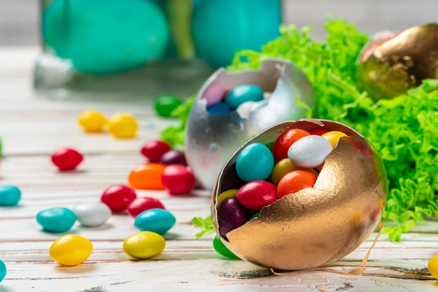 Easter concept.  Eggs and colored sweets on table close up