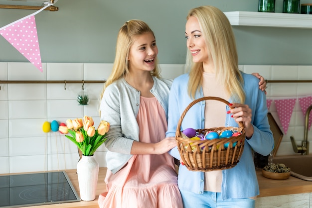 Easter concept, mom has an Easter basket and soap with her daughter.