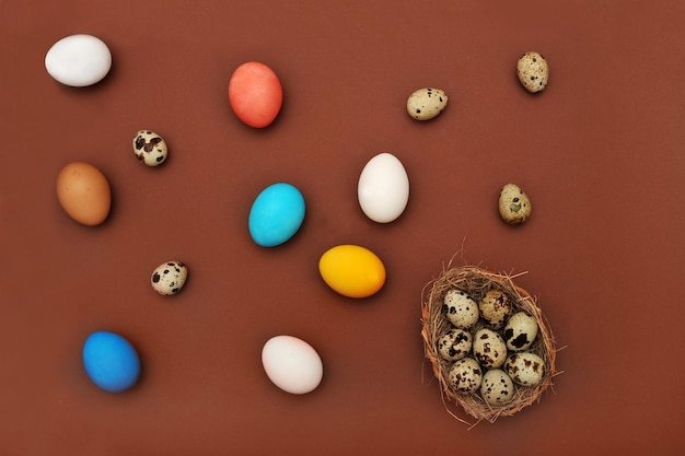 Easter concept painted and quail eggs on a terracotta background View from above