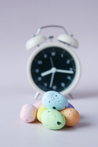 Easter concept with egg and a clock on table