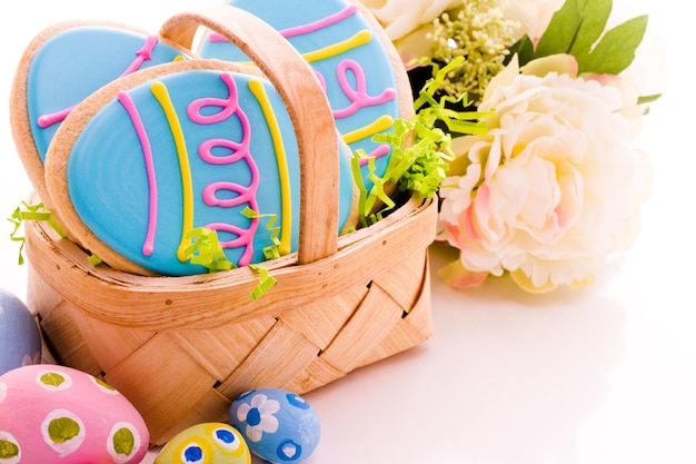 Easter cookies in shape of egg decorated with blue icing.