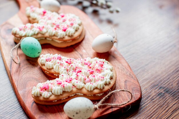 Easter cookies on a wooden board with easter eggs on top