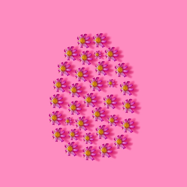 Easter creative concept Pink flowers on pink background Creative color background top view