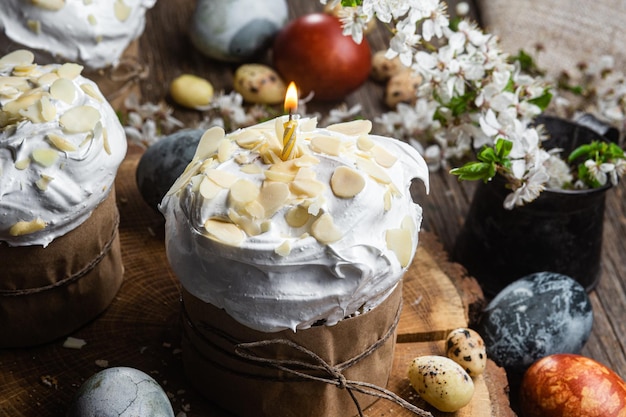 Easter cupcake with meringue and almond petals on a wooden background